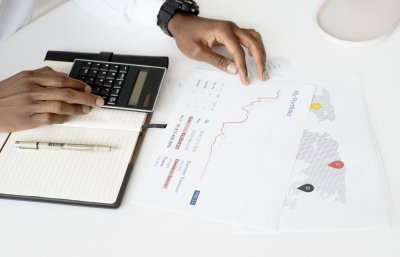 Close-up of pension fund statements or investment portfolio documents with graphs and figures showing investment returns and pension pot values over several years