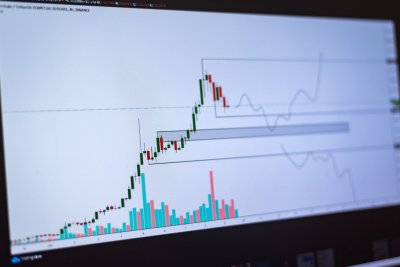 A computer monitor showing graphs, transaction flows, and data dashboards typical of blockchain analysis software interfaces