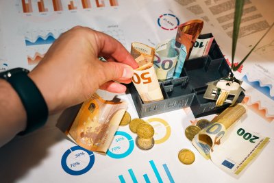 A visual representation of different investment types such as stock market charts, property buildings, bonds documents, and infrastructure like wind turbines or bridges