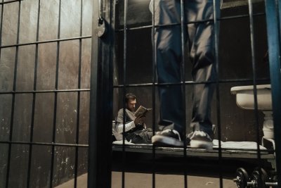 Interior of a prison cell showing multiple bunk beds and confined conditions with limited space