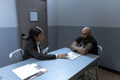 Interior of a plain police interview room with a table and chairs, showing the setting where legal rights like remaining silent are exercised